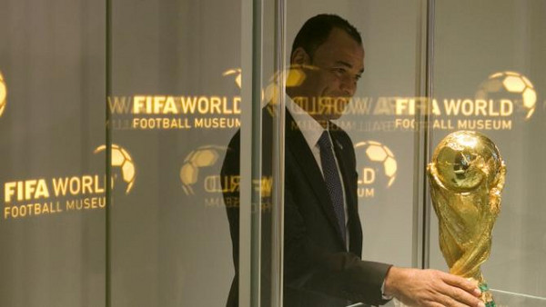 Brazil's former soccer player Cafu places the FIFA World Cup trophy into a glass cabinet during a media preview at the new FIFA World Football Museum in Zurich