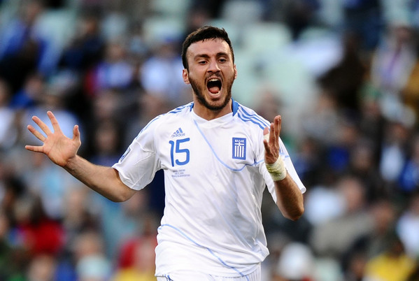 Greece's defender Vasilis Torosidis (R)